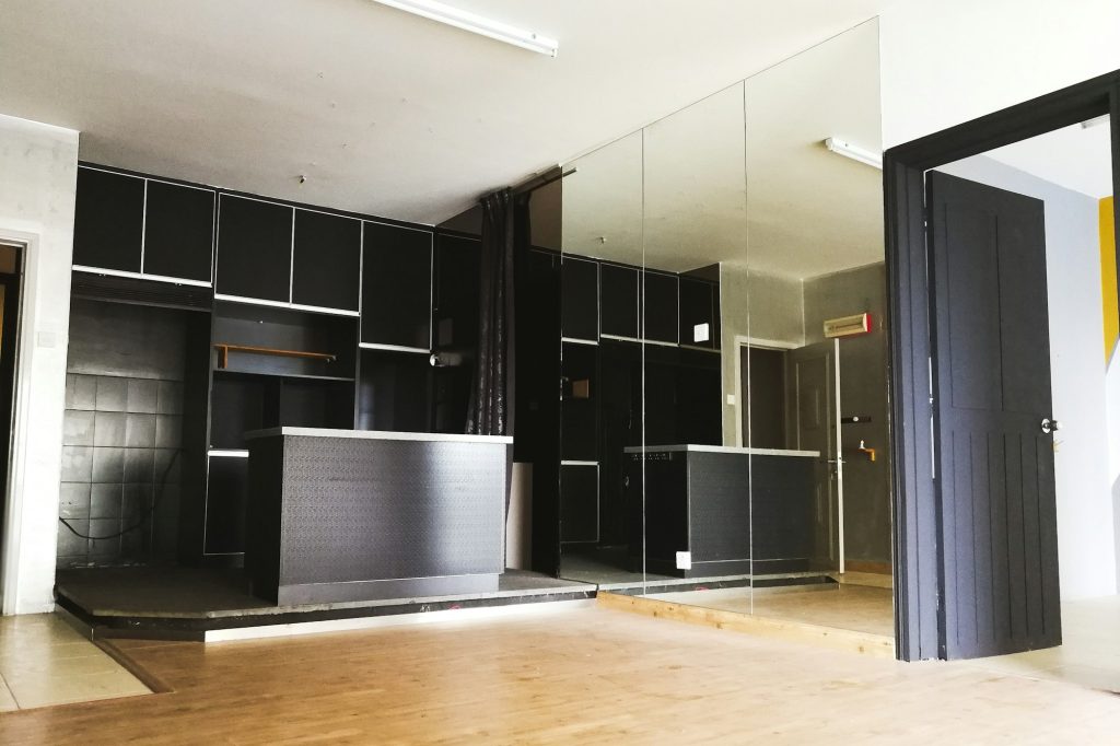 interior of a black kitchen island with glass wall and wooden flooring